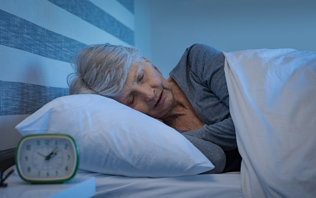 Senior woman sleeping soundly in a bed